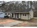 Traditional ranch style home with neutral siding, black shutters, and a concrete driveway at 1471 Cedar Creek Ln, Riverdale, GA 30296