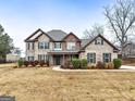 Two-story brick house with landscaped yard and driveway at 209 Enfield Ln, Mcdonough, GA 30252