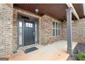 Front door entrance with brick columns and flooring at 209 Enfield Ln, Mcdonough, GA 30252