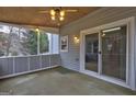 Inviting screened porch with sliding glass doors, perfect for enjoying the outdoors in comfort at 3954 Swathmore Ln, Duluth, GA 30096