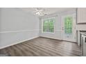 Bright dining area with backyard access, chair rails, and ample natural light at 65 Riverside Way, Sharpsburg, GA 30277