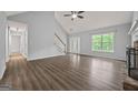 Bright living room features a fireplace, vaulted ceiling, and new flooring with backyard access at 65 Riverside Way, Sharpsburg, GA 30277