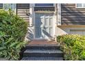 Close-up of the front door with brick steps and lush greenery at 2145 Sandgate Cir, South Fulton, GA 30349