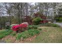 Scenic view of the home surrounded by mature trees and lush landscaping at 731 Willow Ridge Dr, Marietta, GA 30068
