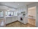Bright kitchen featuring white cabinets and appliances, and hardwood flooring at 731 Willow Ridge Dr, Marietta, GA 30068