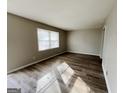 Bright living room with wood-look floors and neutral walls with lots of natural light at 422 Windsor Dr, Forest Park, GA 30297