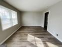 Bright living room with wood-look floors and neutral walls with lots of natural light at 422 Windsor Dr, Forest Park, GA 30297