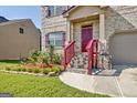 Landscaped front yard with red mulch and flowering plants near house entrance at 633 Mill Creek Trl, Jonesboro, GA 30238