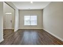 Spacious living room with hardwood floors and large window at 633 Mill Creek Trl, Jonesboro, GA 30238