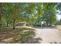 Beautiful single-story home with a lush green lawn and mature trees, offering a serene setting at 950 Old Jackson Rd, Locust Grove, GA 30248