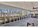 Spacious screened porch overlooking a wooded area with a swing and patio furniture at 102 Morallion Hls, Peachtree City, GA 30269