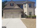 Charming two-story brick home with a two-car garage and manicured landscaping at 12226 Flannery Ln, Hampton, GA 30228