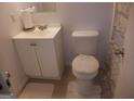 Bathroom featuring white fixtures, a sink cabinet, and a neutral-colored shower curtain at 3248 Brisbane Way, Lithonia, GA 30038