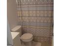 Cozy bathroom showcases a toilet with a patterned shower curtain at 3248 Brisbane Way, Lithonia, GA 30038