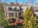 House with a wrap-around porch and mature trees at 811 Somersby Dr, Dallas, GA 30157