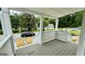 Relaxing front porch with white lattice details and steps leading to the yard at 1222 Bronx Nw St, Atlanta, GA 30314