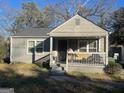 Ranch style home with covered porch and small yard at 561 Commercial Nw Ave, Atlanta, GA 30318