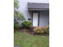 Inviting front entrance with landscaping and a large potted plant at 97 Willowick Dr, Lithonia, GA 30038