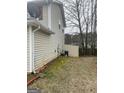 Backyard with AC unit, moss, and an open grassy space at 1611 Cobbs Creek Ln, Decatur, GA 30032