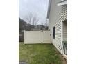 Backyard with a white privacy fence and green grass leading up to the side of a house at 1611 Cobbs Creek Ln, Decatur, GA 30032