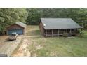 Log cabin home with detached garage and large backyard at 184 Elm St, Covington, GA 30014