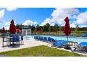 Resort-style pool area with lounge chairs, umbrellas, and a splash fountain for community residents at 157 Aster Ave, Locust Grove, GA 30248