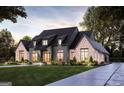Modern farmhouse style home with brick and dark siding, landscaping, and a paved driveway at 0 Matteo Way # 7, Fayetteville, GA 30215