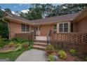Front entrance of a brick house with a walkway and landscaping at 215 Creekside Trl, Fayetteville, GA 30214