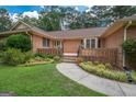 Brick house entrance with steps leading to a covered porch at 215 Creekside Trl, Fayetteville, GA 30214
