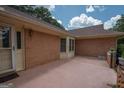 Brick house showcasing a patio and side yard at 215 Creekside Trl, Fayetteville, GA 30214