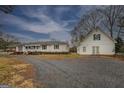 A single story home with large yard and a detached garage on a stone driveway at 12178 Brown Bridge Rd, Covington, GA 30016