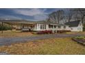 Ranch style home featuring a covered carport and well manicured flowerbeds at 12178 Brown Bridge Rd, Covington, GA 30016