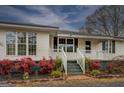 A inviting front porch with fresh landscaping, white railings, and well-kept stairs at 12178 Brown Bridge Rd, Covington, GA 30016