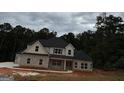 Two-story house with gray brick and white accents, a black roof, and a large driveway at 8795 St Patrick'S Way # 2, Winston, GA 30187