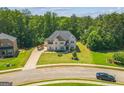 An elevated view showcases this two-story home, its lush lawn, and convenient street access at 4051 Rotterdam Pass, Hampton, GA 30228