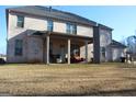 Brick house with a large covered patio and grassy backyard at 4051 Rotterdam Pass, Hampton, GA 30228