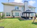 Home's backyard with gazebo, patio furniture, and fire pit at 10 Toscanno Dr, Covington, GA 30014