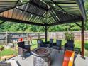 Covered patio with fire pit and wicker furniture at 10 Toscanno Dr, Covington, GA 30014