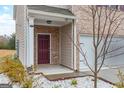 Townhome entry with burgundy door and stone accents at 3170 Fareed St, Douglasville, GA 30135