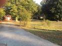 Ranch house with a detached building, chain link fence, and large yard at 1810 Highway 138 E, Stockbridge, GA 30281