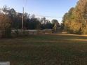 Open vacant lot near a road with sparse trees at 1810 Highway 138 E, Stockbridge, GA 30281