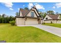 View of the home's side elevation, showcasing the garage and landscaping at 210 Regester Way # 42, Peachtree City, GA 30269