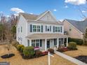 Two-story house with gray siding, a front porch, and landscaping at 300 South Village Sq, Canton, GA 30115