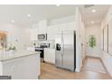 Modern kitchen with white cabinets, granite countertops, stainless steel appliances, and hardwood floors at 1935 Westwind Street # 157, Lawrenceville, GA 30043