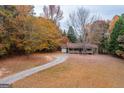 House with driveway, surrounded by colorful autumn trees at 2949 Hog Mountain Rd, Dacula, GA 30019