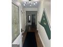 Bright entryway with a stylish light fixture and access to other rooms at 1441 Evans Dr, Riverdale, GA 30296