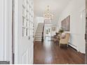 Bright entryway with hardwood floors, chandelier, and staircase at 3115 Pennington Sw St, Covington, GA 30014