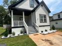 Two-story house with white siding and black accents, featuring a front porch and landscaping at 78 Bisbee Se Ave, Atlanta, GA 30315