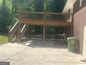 Exterior featuring a wooden deck, concrete patio, and brick siding at 2362 Maxwell Dr, Atlanta, GA 30311