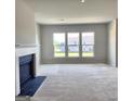Bright living room with fireplace and large windows at 212 Himalaya Way, Mcdonough, GA 30253
